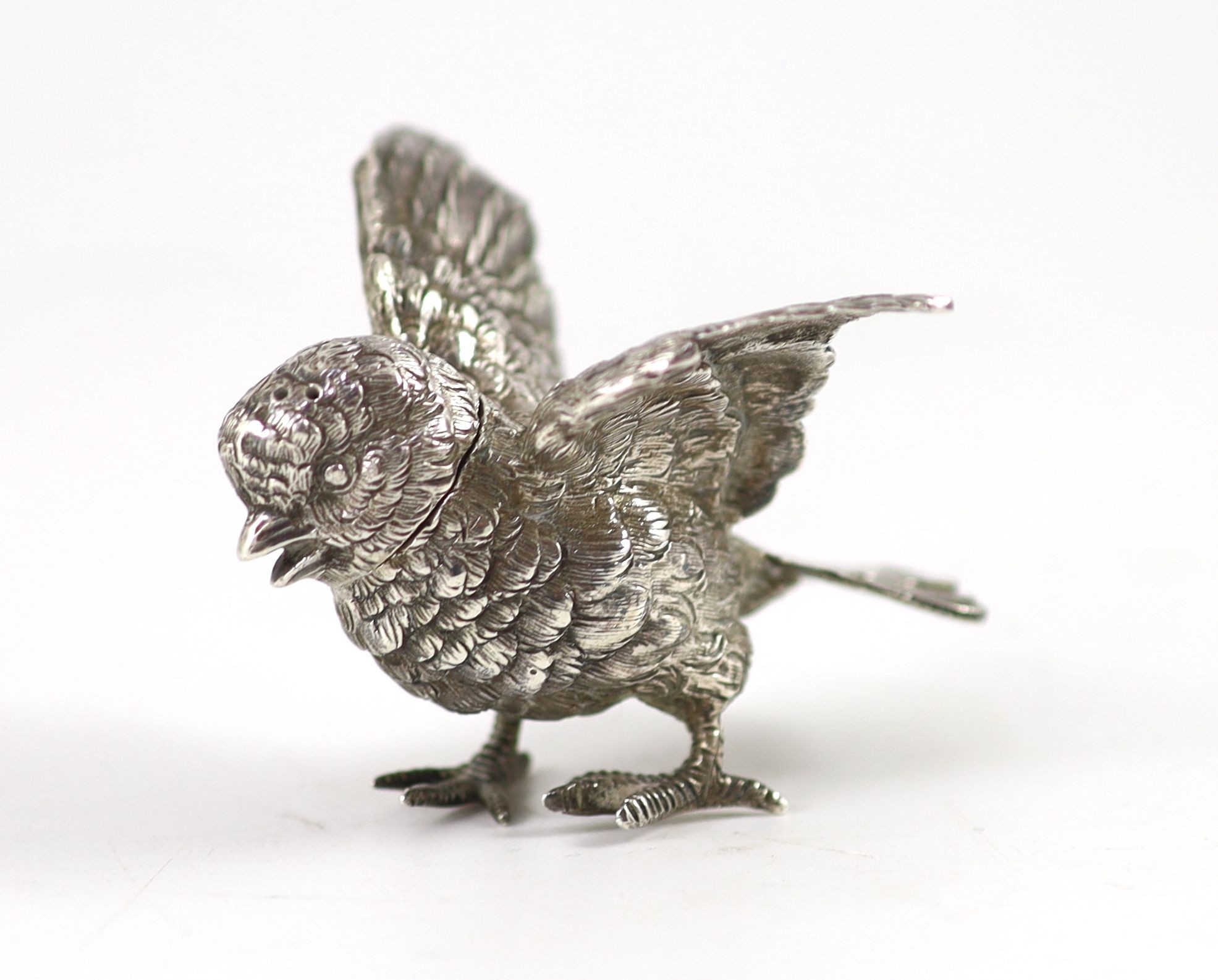 A late 19th/early 20th century Hanau novelty silver pepperette, modelled as a chick with outspread wings